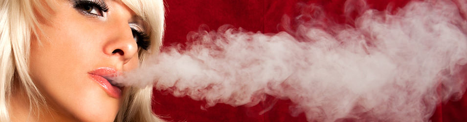 Beautiful woman smoking a hookah and smoke issues from the mouth